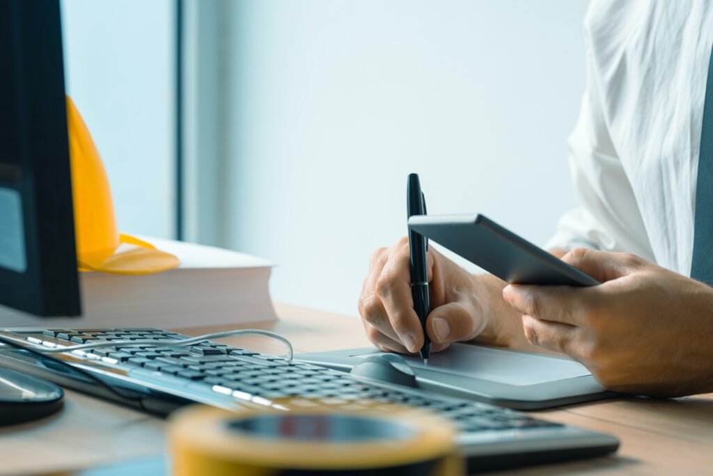 Architect working with sketch pen tablet and CAD software