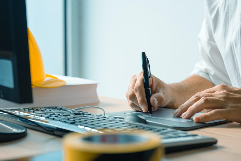 Architect working with sketch pen tablet and CAD software